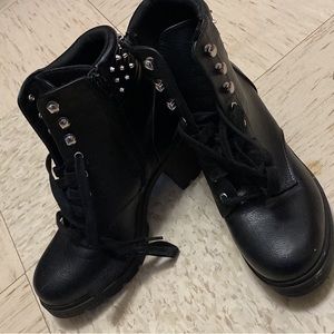 Black leather high heeled boots with spikes.